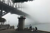 The Sydney Harbour Bridge, partly hidden by fog.