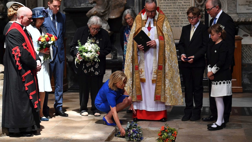 Lucy Hawking lays flowers on the ashes of Stephen Hawking at his memorial service.