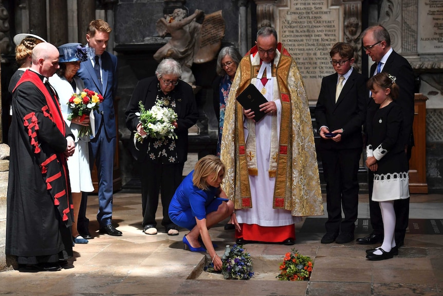Lucy Hawking lays flowers on the ashes of Stephen Hawking at his memorial service.