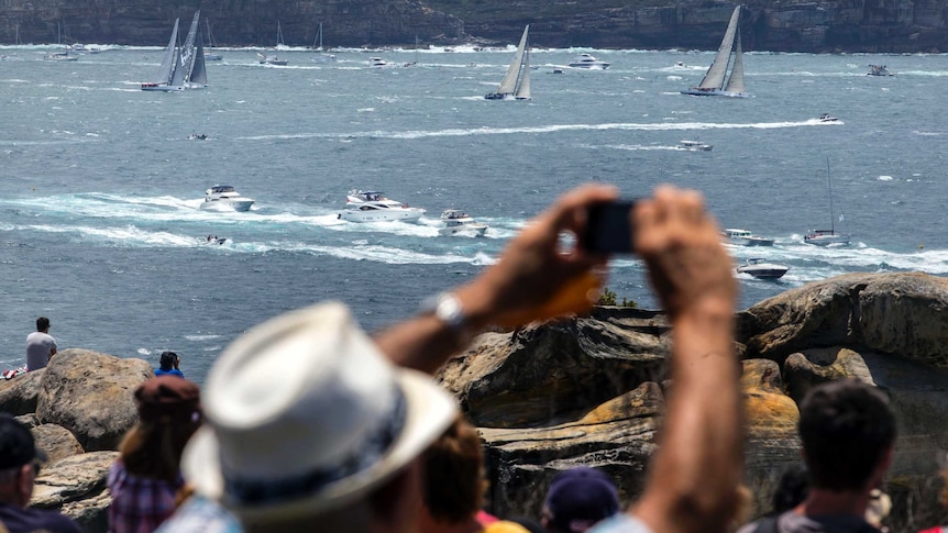 Spectators watch the Sydney to Hobart yacht race at The Gap, Watsons Bay.