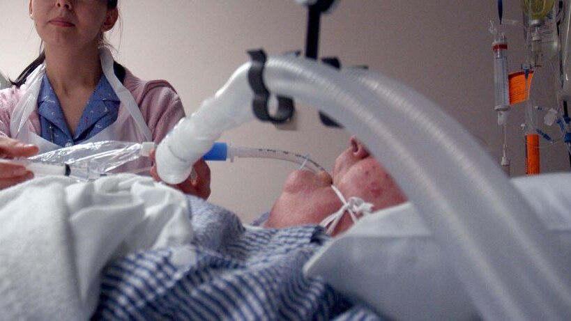 A nurse tends to a patient in an intensive care unit, June, 2008.