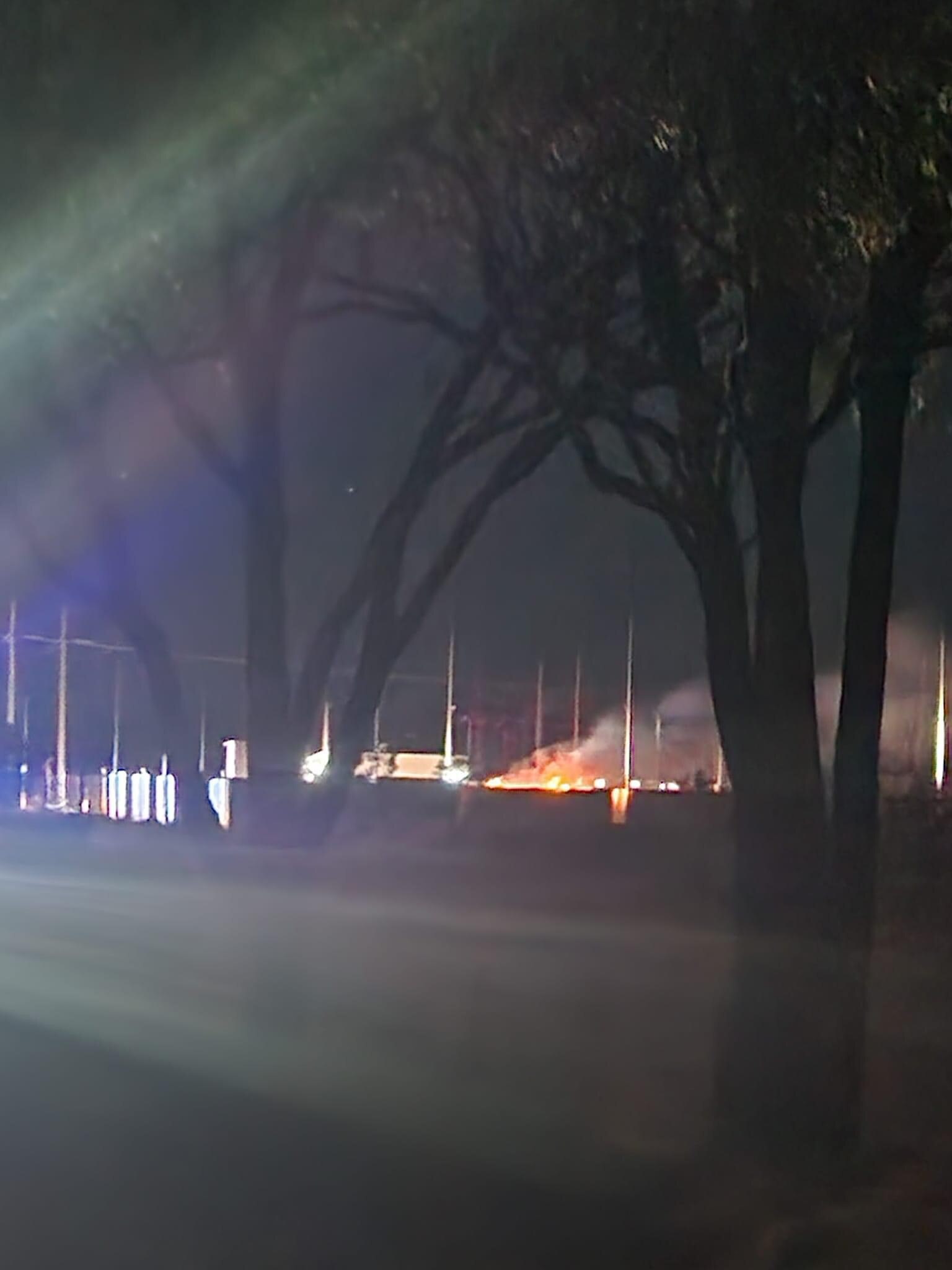 A fire rages at an industrial site at night.
