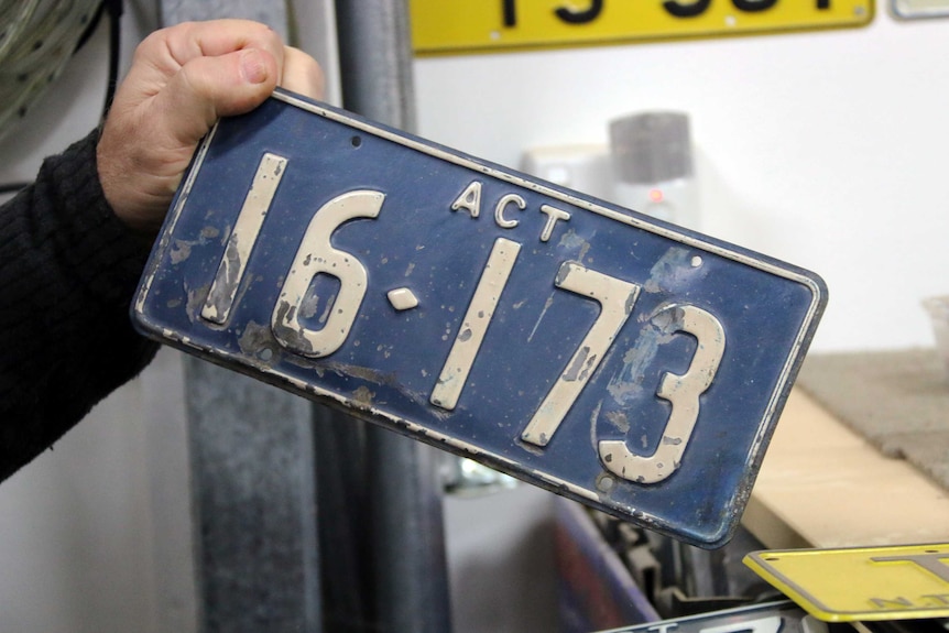 A close up of an early ACT number plate featuring only numbers.