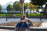 Women console each other outside the White House on the day of US election