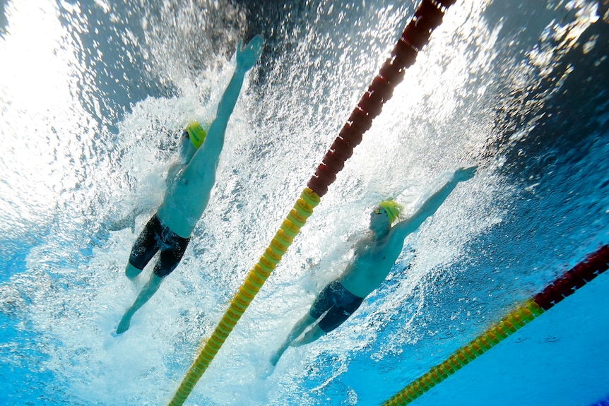 Two Australians swimmers competing in the heats of the 400 metres freestyle at the Tokyo Olympics.