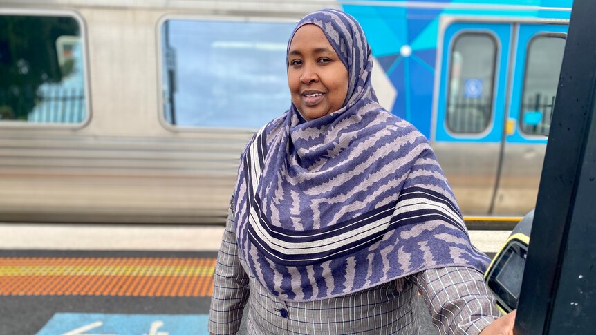 Anaab Rooble wears a hijab as she waits for a train at a station. 