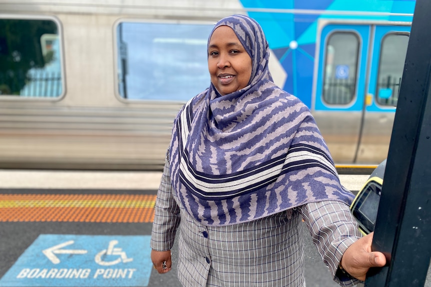 Anaab Rooble wears a hijab as she waits for a train at a station. 