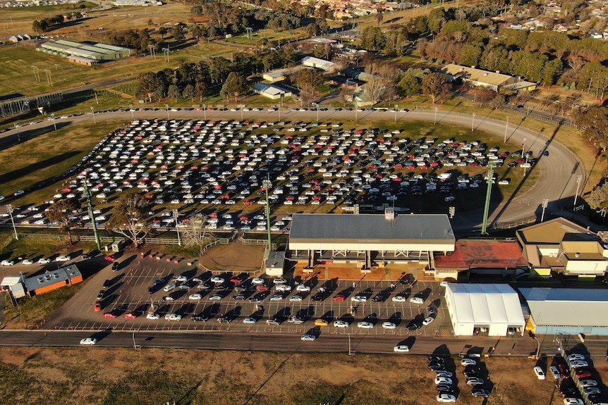 Aerial pictures of cars lining up to be tested at a COVID-19 surge centre