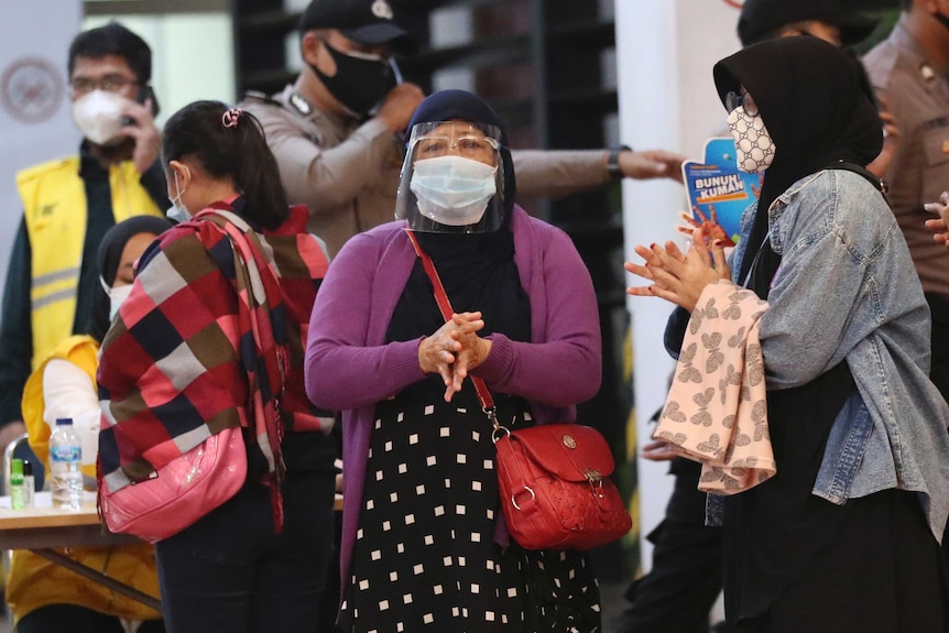 Relatives of passengers arrive at a crisis centre set up at Jakarta airport