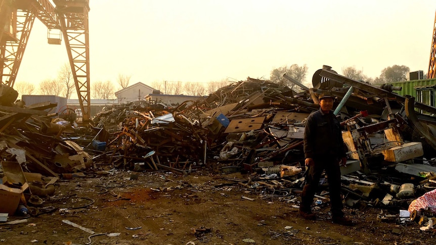 A worker at a scrap metal recycling facility at Tongzhou, Beijing.