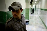 A prison guard stands along a corridor in Tehran's Evin prison.