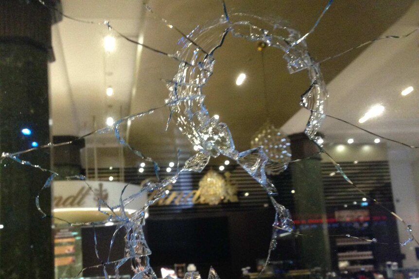 Holes in the windows of the Lindt Cafe in Sydney's Martin Place