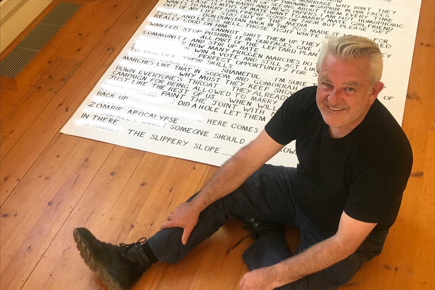 Noel Hourigan pictured with his confronting artwork