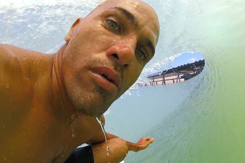 a gopro point of view shot of kelly slater inside a barrel