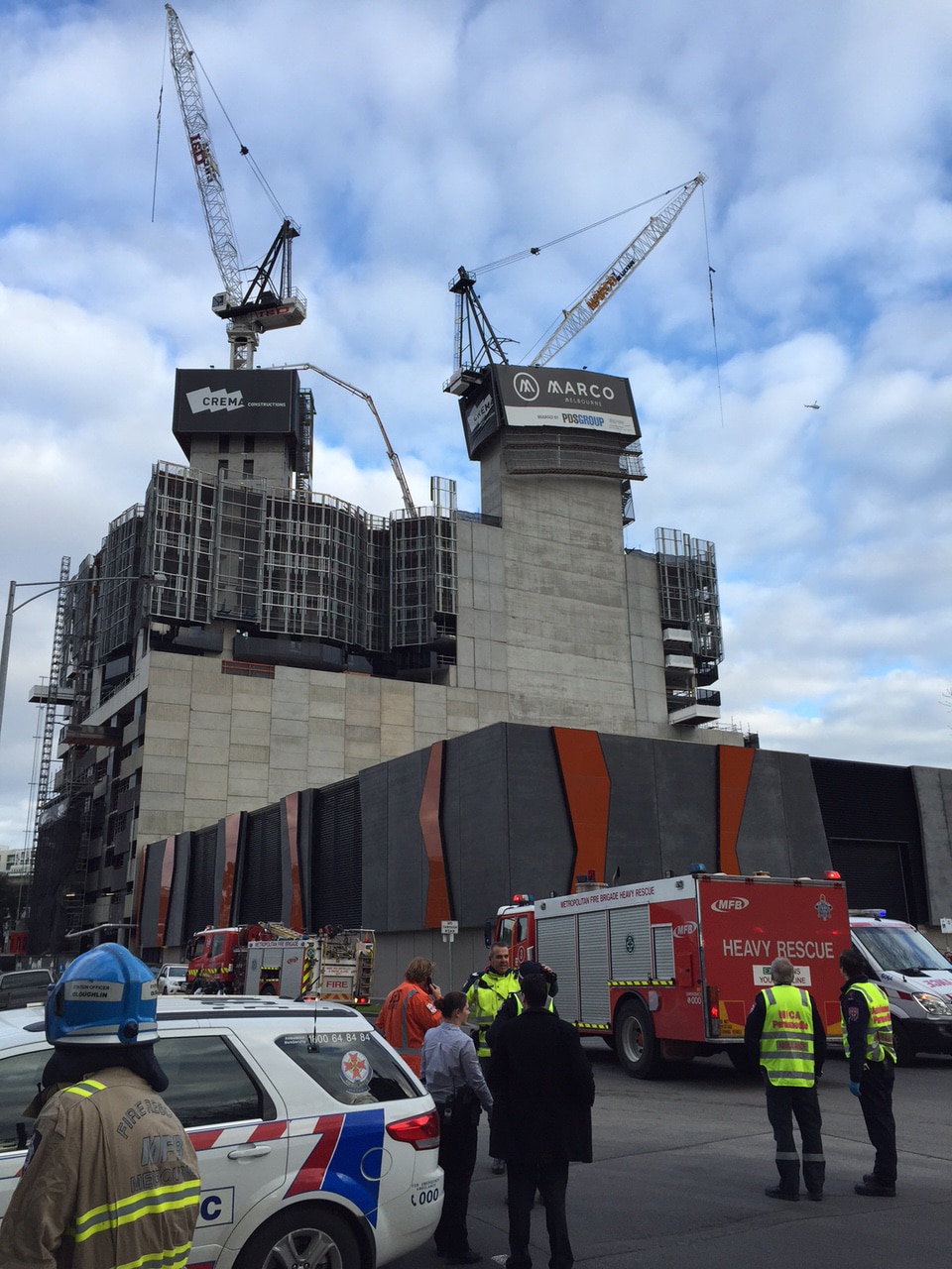 Crane collapses at Melbourne construction site, one person treated for