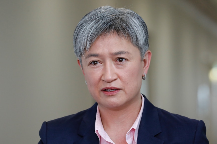 A close shot of Penny Wong, who has short grey hair, speaking indoors with a neutral expression.