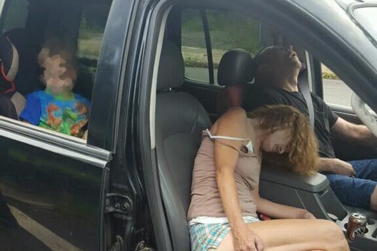 An unconscious couple sit in their car