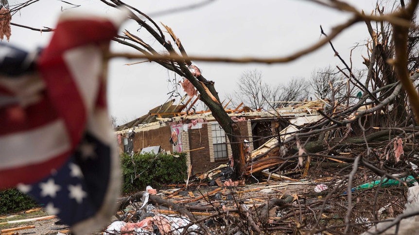 An American flag hangs outside a Texas home destroyed by tornadoes.
