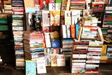 A pile of books stacked for sale