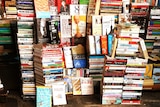 A pile of books stacked for sale