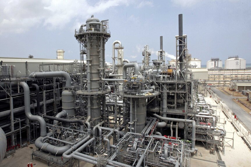 An intricate network of grey pipes at a Qatari natural gas facility is shown.