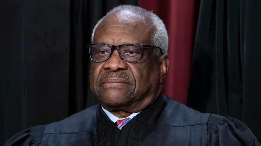 A photo of Justice Clarence Thomas as he poses for a portrait. 