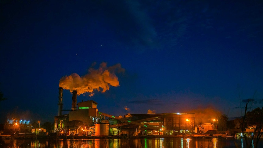A factory lit up at night.