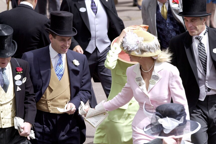 Prince Andrew wearing a top hat and tails walks through a crowd with Jeffrey Epstein, also in top hat and tails