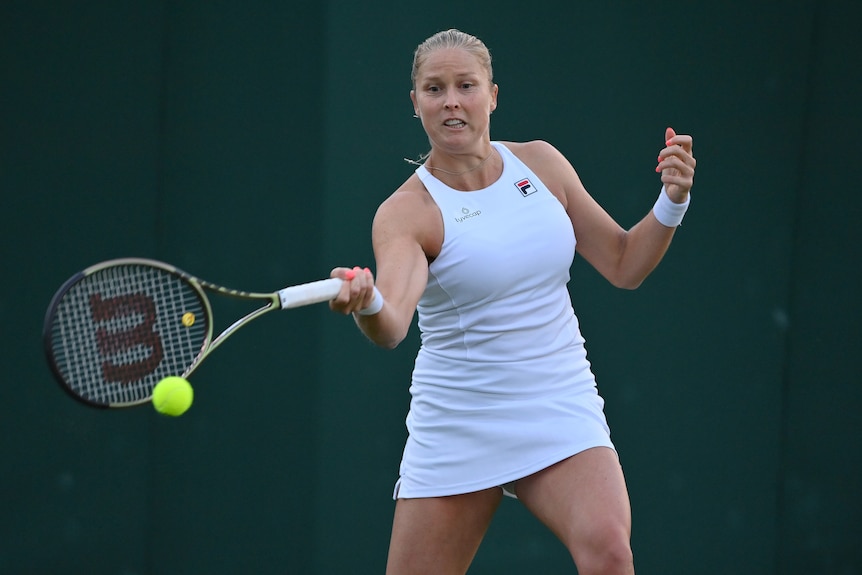 Shelby Rogers plays a forehand during the Wimbledon 2022 tournament, dressed in a white FILA dress