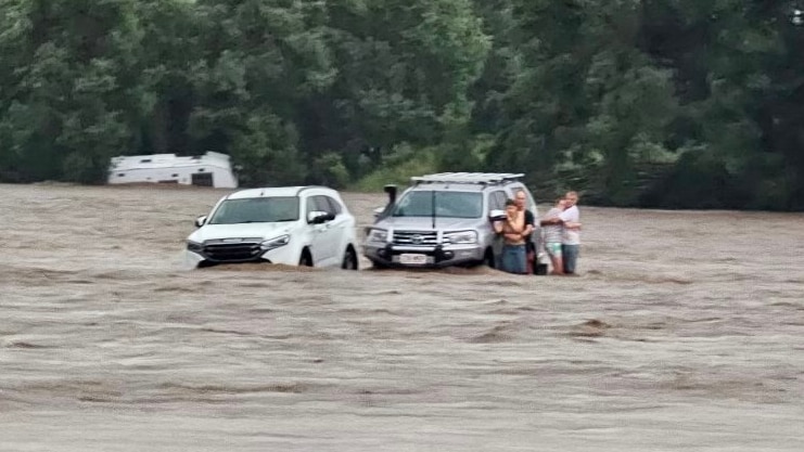 Campers being rescued in flood water.