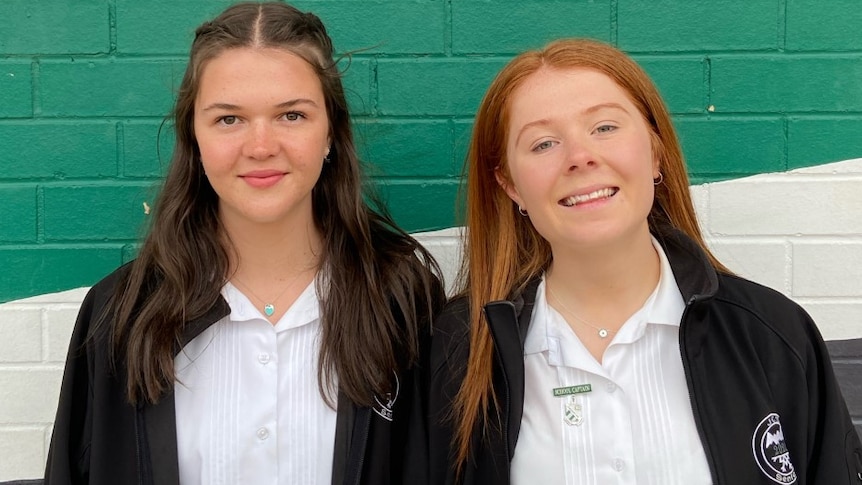 Jindabyne high school students smiling at school .