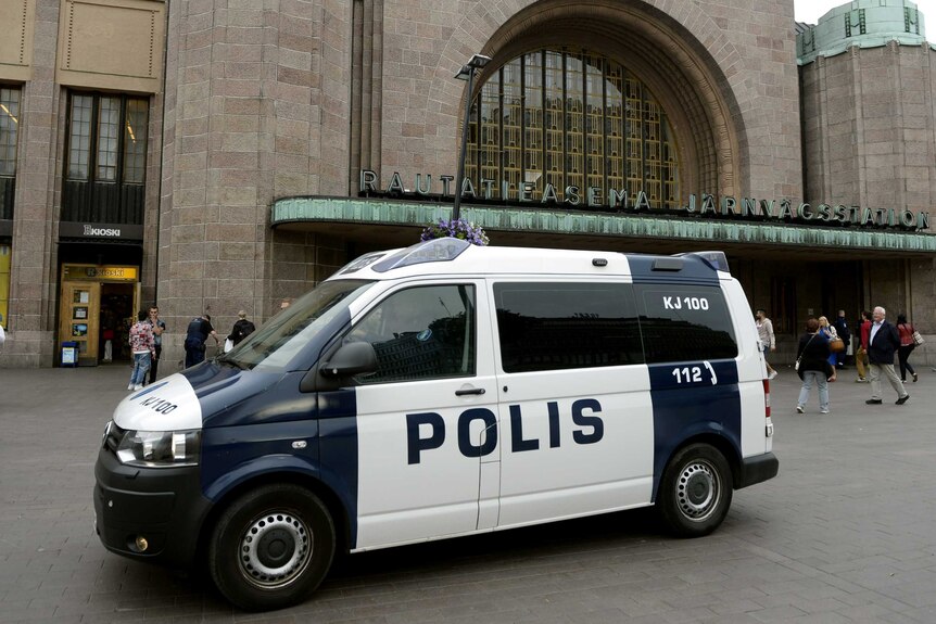 Police van sits outside a major railway station.