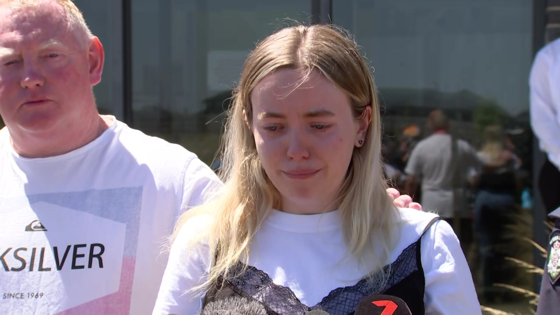 Jess Murphy crying, standing in front of her dad.