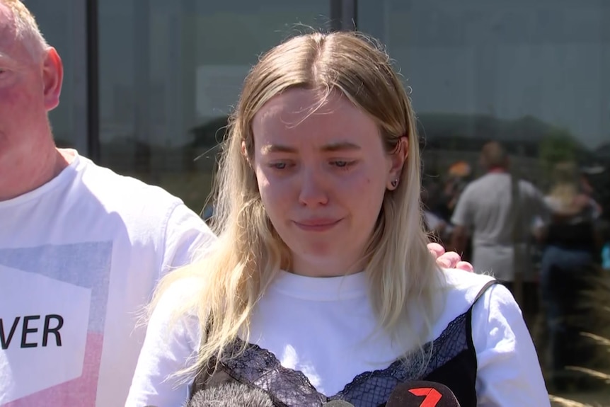 Jess Murphy crying, standing in front of her dad.