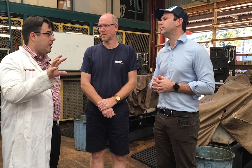 Matt Canavan speaks with two men at a workshop