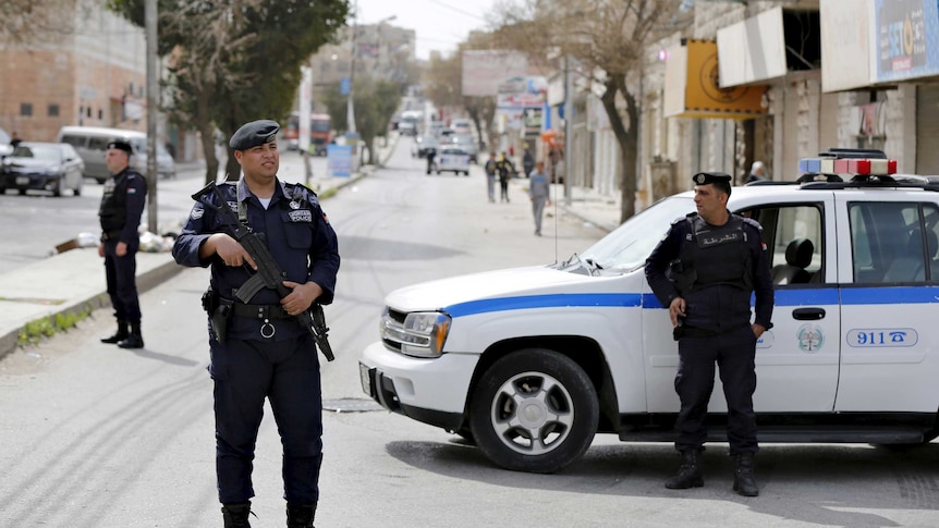 Officers of the Jordanian public security department stand guard in the northern city of Irbid