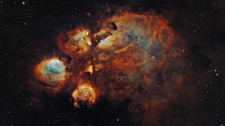 Deep orange and blue and red cloudy cluster of stars