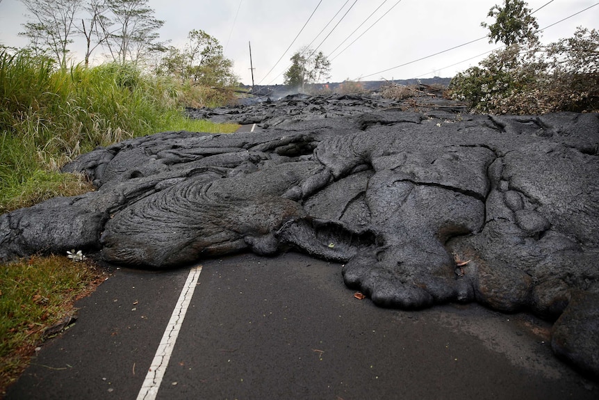 Lava covers Pohoiki Road near Pahoa in Hawaii after a volcano erupted.