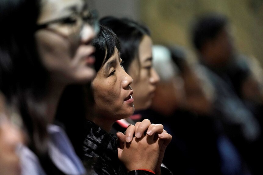 Believers take part in a weekend mass at Beijing South Catholic Church in Beijing