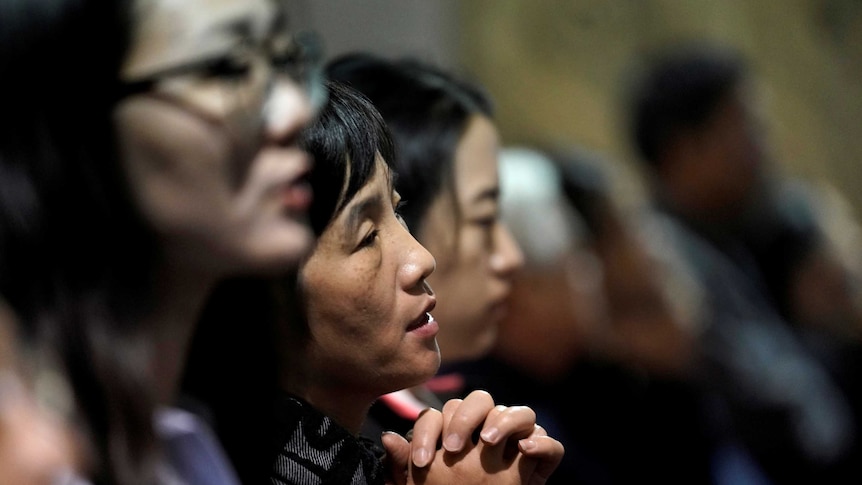 Believers take part in a weekend mass at Beijing South Catholic Church in Beijing