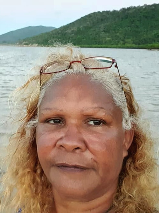 An Indigenous woman standing on an island beach