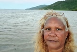 An Indigenous woman standing on an island beach