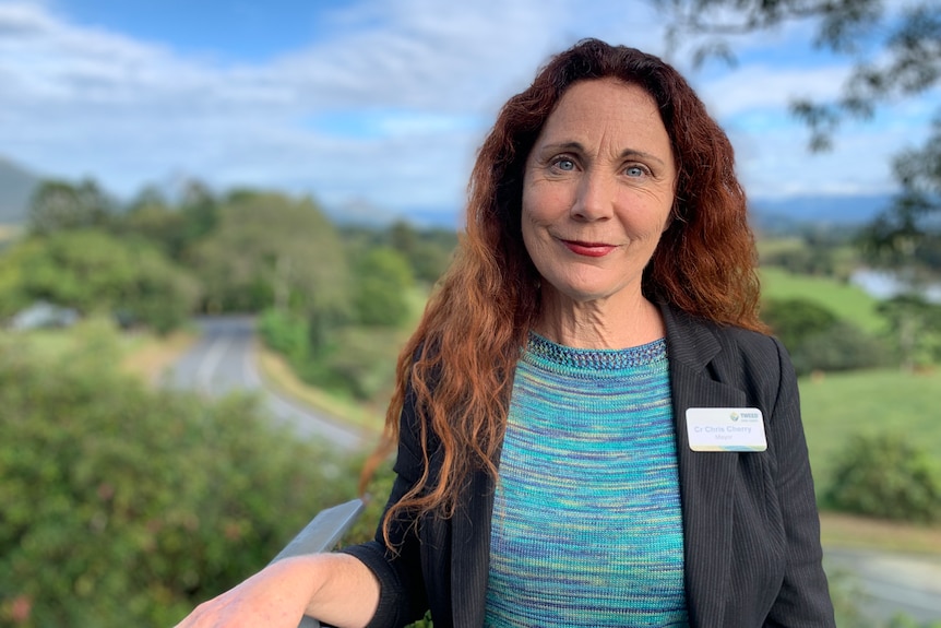 Tweed Mayor Chris Cherry smiling with river and green paddocks behind her