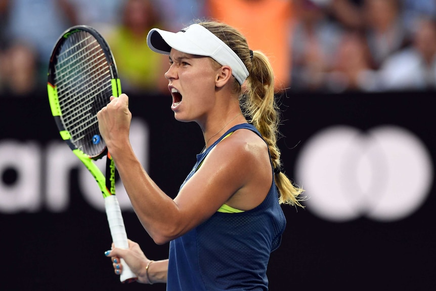 Caroline Wozniacki pumps her fist as she celebrates a point in the Australian Open final.