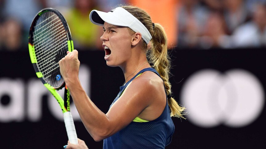 Caroline Wozniacki pumps her fist as she celebrates a point in the Australian Open final.