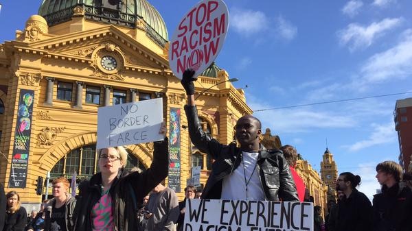 Demonstrators gather outside Flinders Street Station in Melbourne's CBD.