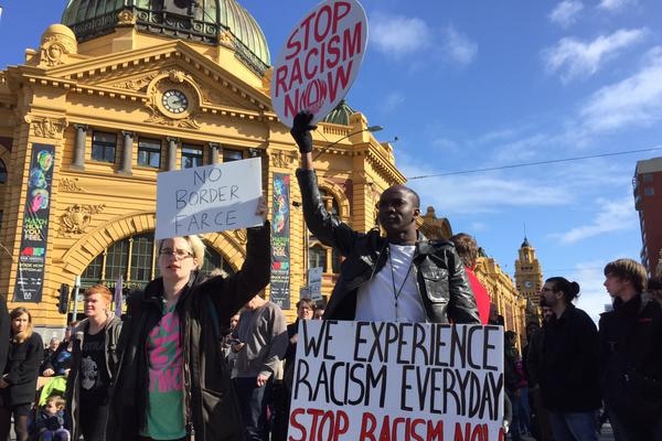 Demonstrators gather outside Flinders Street Station in Melbourne's CBD.