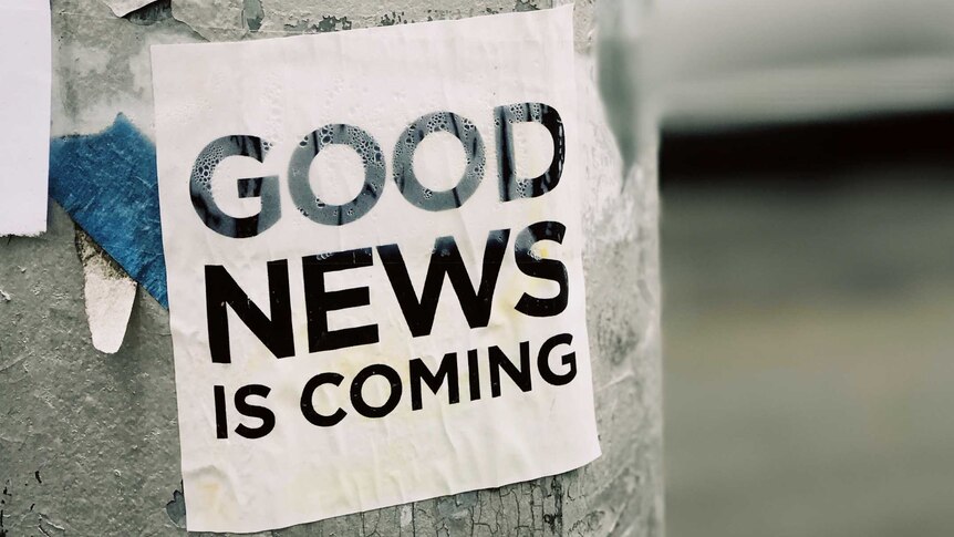 A street post with a piece of paper saying "Good News is Coming"