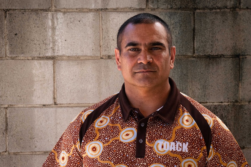 Ngunnawal man Richie Allan standing in front of a concrete wall