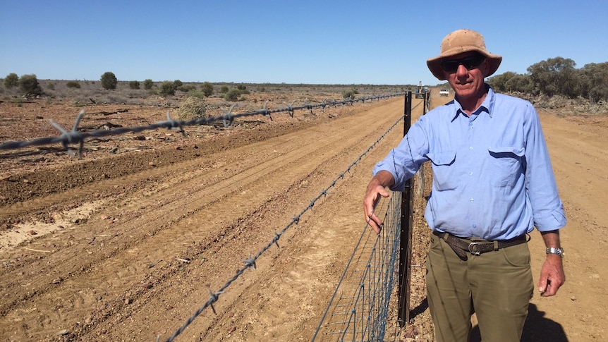 Jack Banks with the wild dog fence being built on his land